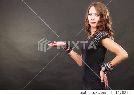 Elegant woman wearing bracelets holds open hand Elegant woman wearing bracelets holds open hand 113478234
