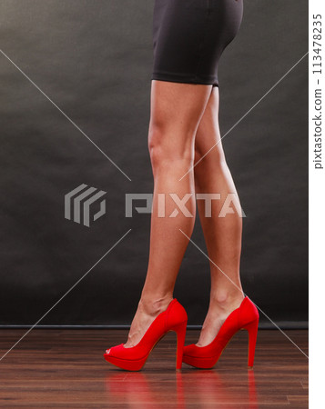 Red high heels spiked shoes on sexy female legs Red high heels spiked shoes on sexy female legs 113478235