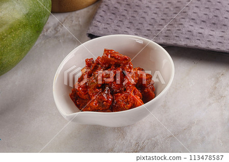 Spicy pickled raw green mango Spicy pickled raw green mango 113478587