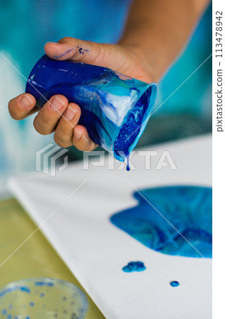 Artistic Blue Paint Pouring on Canvas 113478942