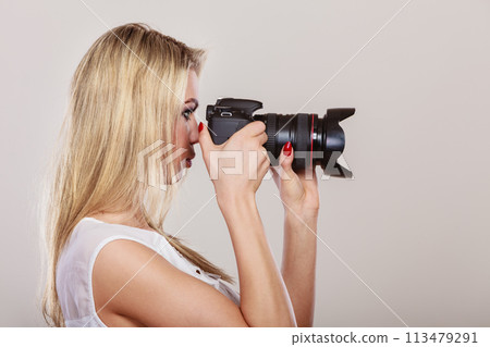 Beautiful woman with camera. 113479291