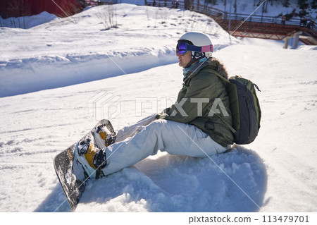 Snowboarder's Rest on the Mountain 113479701