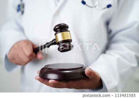 Asian doctor holding court hammer for and crime law justice, forensic medicine. Asian doctor holding court hammer for and crime law justice, forensic medicine. 113481585
