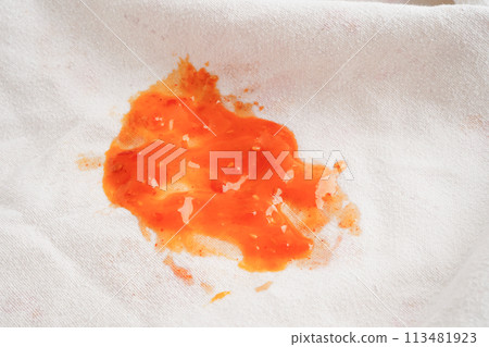 Dirty tomato sauce stain or ketchup on cloth to wash with washing powder, cleaning housework concept. 113481923