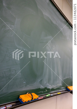 School blackboard. Faintly remaining letters on the blackboard. School blackboard. Faintly remaining letters on the blackboard. 113482871