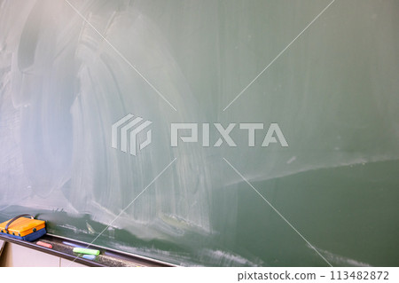 School blackboard. Faintly remaining letters on the blackboard. School blackboard. Faintly remaining letters on the blackboard. 113482872