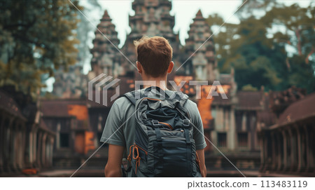 Rear view of a young man carrying a backpack to tour the temple. 113483119