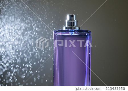 Perfume spray in a violet bottle on a dark background. Perfume spray in a violet bottle on a dark background. 113483650