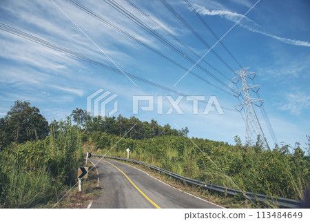 High voltage pole electric wiring distribution landscape energy engineering. Electricity energetic background with blue sky green mountain in countryside. Electric power energy engineering industrial 113484649