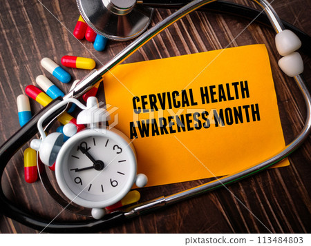 Top view clock,stethoscope,pill capsule and colored notepaper with text CERVICAL HEALTH AWARENESS MONTH on wooden background 113484803