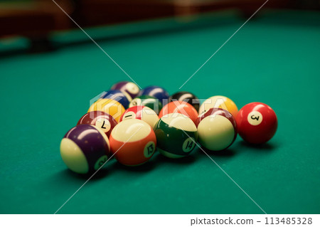 Close up background image of billiard balls on green table in pool club copy space Close up background image of billiard balls on green table in pool club copy space 113485328