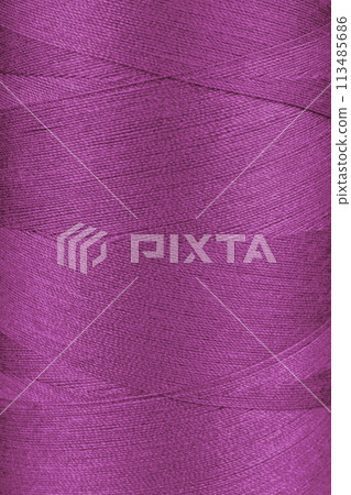 Texture of pink color threads in spool close up, macro 113485686