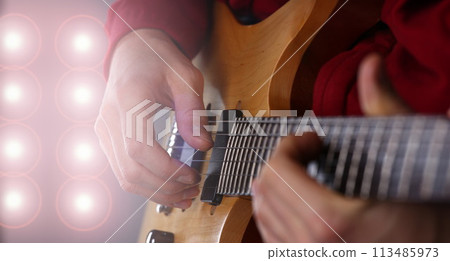 Male arms playing classic shape electric guitar Male arms playing classic shape electric guitar 113485973