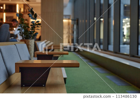 Minimal geometric image of seating row facing windows in hotel lobby or office building interior copy space 113486130
