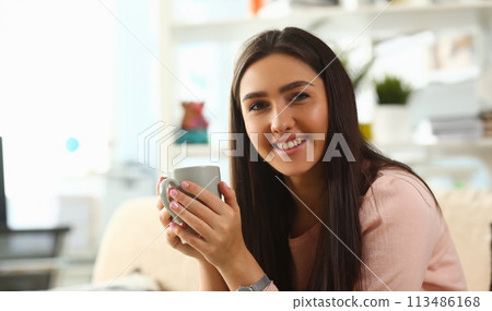 Indian woman holds mug her hand smiles Indian woman holds mug her hand smiles 113486168