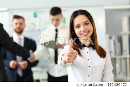 Female arm show OK or approval with thumb 113486472