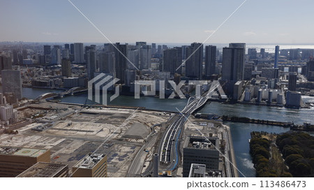 Kachidoki, the former Tsukiji Market site, and Tsukiji Ohashi Bridge as seen from the observation deck of the Caretta Shiodome complex, a high-rise building in Shiodome, Tokyo. 113486473