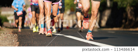 Marathon running race, people feet on city road 113486614