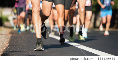 Marathon running race, people feet on city road 113486615