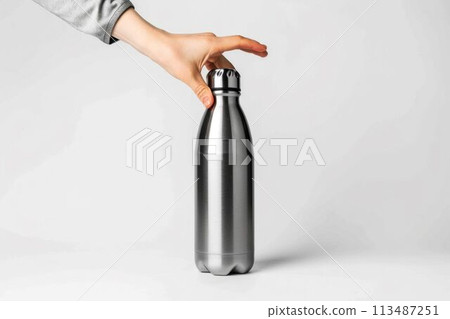 Hand Holding a Stainless Steel Water Bottle. Generative ai 113487251