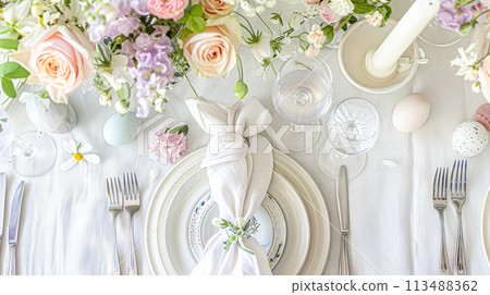 Easter table setting with painted eggs, spring flowers and crockery 113488362