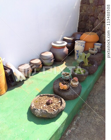 Pots of miso and soy sauce in the garden of a Korean house Pots of miso and soy sauce in the garden of a Korean house 113488508