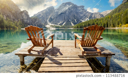 Two Adirondack Chairs on a Wooden Pier on a Beautiful Mountain Lake - Generative Ai 113488716