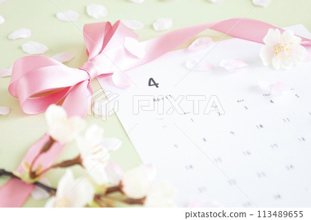 April calendar with light green background - A soft and fluffy image of spring with cherry blossoms falling in the air April calendar with light green background - A soft and fluffy image of spring with cherry blossoms falling in the air 113489655