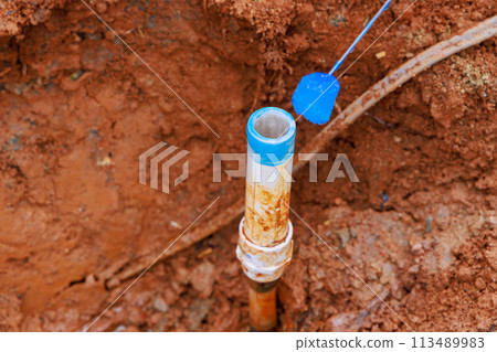 Prior to gluing pvc plastic pipe, plumber seals it with glue 113489983