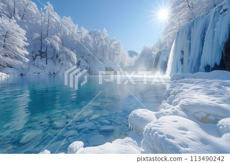 Winter landscape with frozen waterfall and snow covered trees in cold sunny weather 113490242
