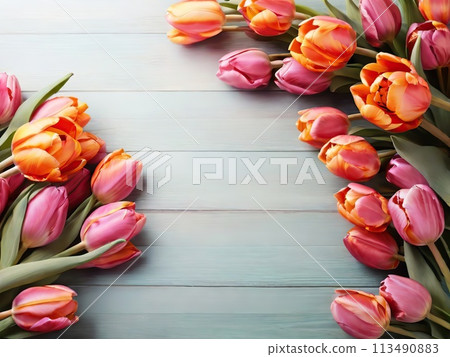 Beautiful tulips on light blue wooden background, top view. Space for text 113490883
