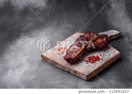 Delicious juicy beef tbone steak with salt, spices and herbs Delicious juicy beef tbone steak with salt, spices and herbs 113491037