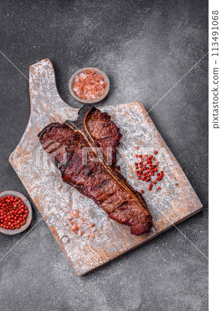 Delicious juicy beef tbone steak with salt, spices and herbs 113491068