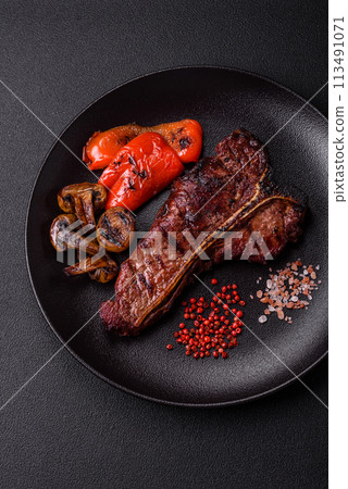 Delicious juicy beef tbone steak with salt, spices and herbs Delicious juicy beef tbone steak with salt, spices and herbs 113491071