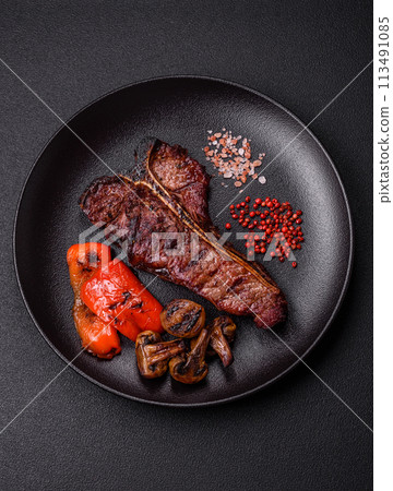Delicious juicy beef tbone steak with salt, spices and herbs Delicious juicy beef tbone steak with salt, spices and herbs 113491085