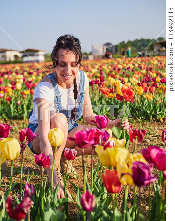 happy female workers trimming flowers in greenhouse happy female workers trimming flowers in greenhouse 113492113