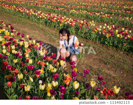happy female workers trimming flowers in greenhouse happy female workers trimming flowers in greenhouse 113492115