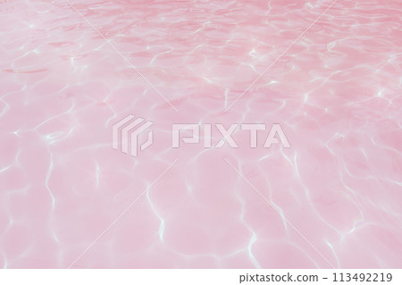 Underwater view in a pool with light refraction on a bright pink surface. Underwater view in a pool with light refraction on a bright pink surface. 113492219
