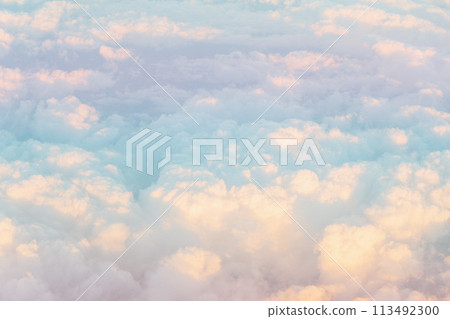 Aerial view of gradient pastel colors of fluffy colorful clouds. Copy space background. Aerial view of gradient pastel colors of fluffy colorful clouds. Copy space background. 113492300