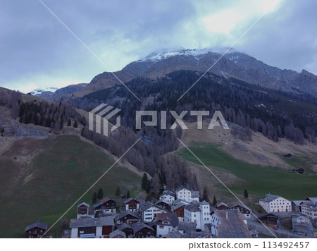 Mountain with snow, on top of a mountain. Forest with the city. Alps Mountain with snow, on top of a mountain. Forest with the city. Alps 113492457