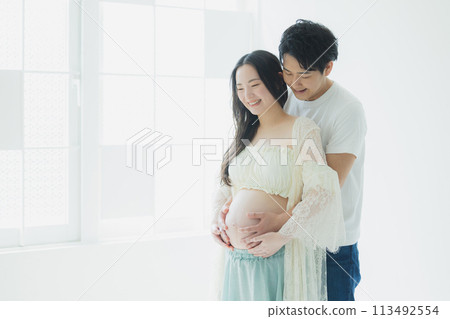 A husband supporting a pregnant woman A husband supporting a pregnant woman 113492554