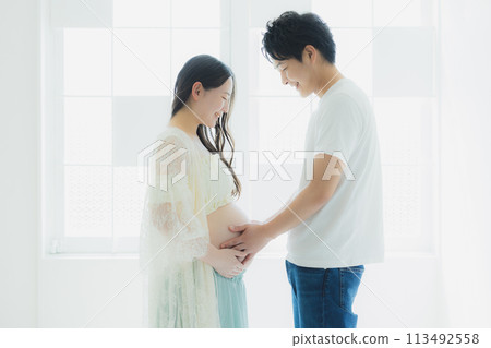 A husband supporting a pregnant woman A husband supporting a pregnant woman 113492558