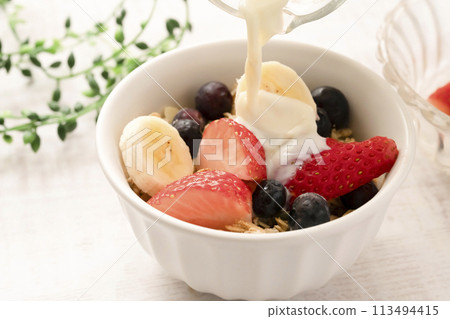 Granola, cereal, soy milk, strawberries, blueberries, bananas 113494415