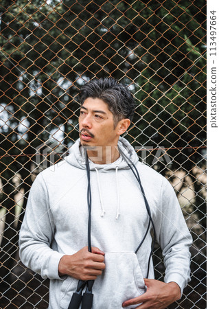 Portrait of a man in his 40s wearing training wear Portrait of a man in his 40s wearing training wear 113497664