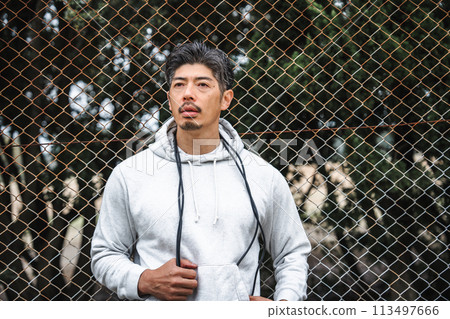 Portrait of a man in his 40s wearing training wear Portrait of a man in his 40s wearing training wear 113497666