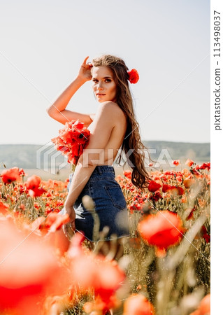 Woman poppies field. portrait happy woman with long hair in a poppy field and enjoying the beauty of nature in a warm summer day. 113498037