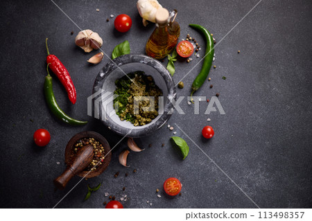 stone mortar with green sauce chopped ingredients 113498357