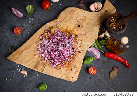 Chopped red Mars Onion on wooden cutting board at domestic kitchen 113498358