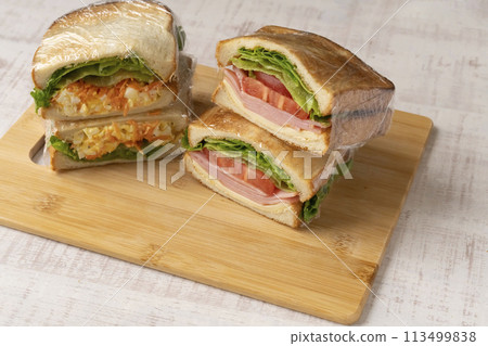 Sandwich making process: Cutting cheese, tomato, and ham Sandwich making process: Cutting cheese, tomato, and ham 113499838