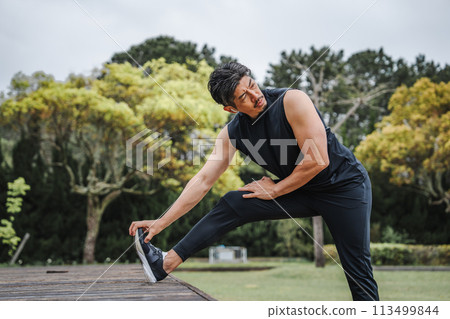Man doing flexibility exercises outdoors 113499844